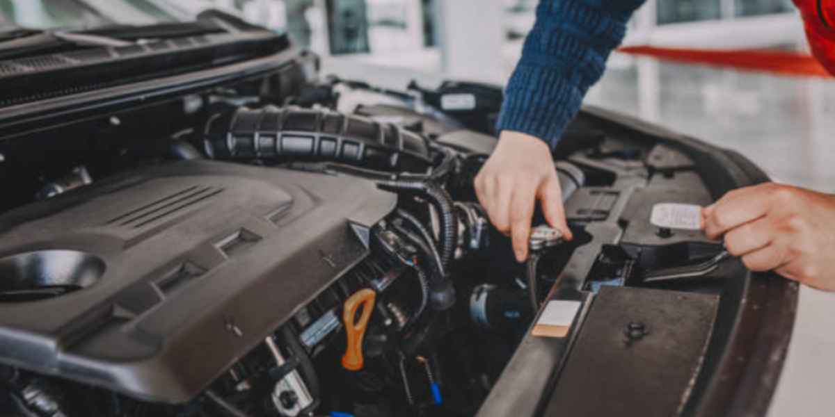 checking engine compartment to find car tracker